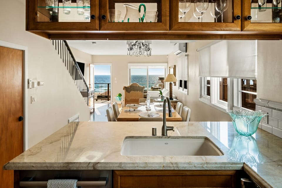 From the kitchen sink to the horizon—luxury and tranquility blend effortlessly in this oceanfront home.