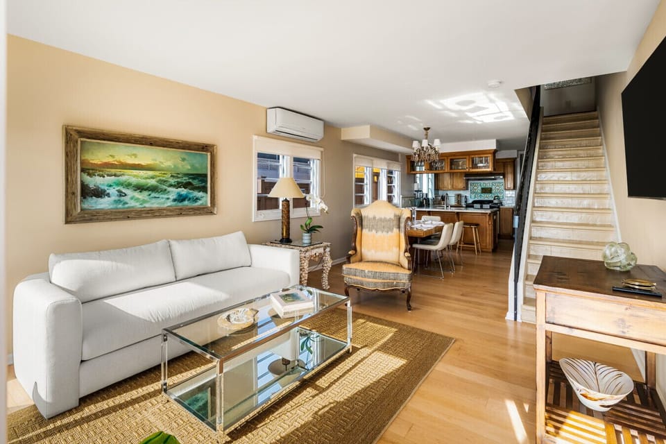 Modern simplicity and coastal charm unite in this oceanfront haven with seamless indoor-outdoor flow.