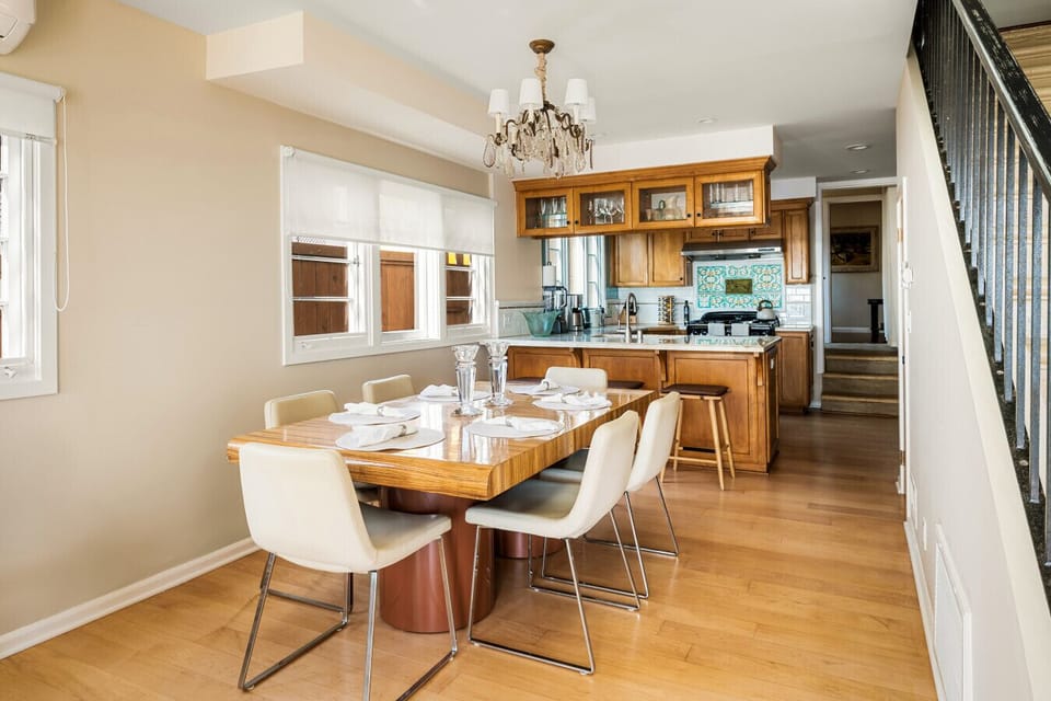 A cozy blend of classic and coastal, this inviting dining area and kitchen set the stage for unforgettable gatherings and everyday elegance.