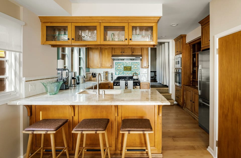 Coastal charm meets elegance in this open-concept kitchen and dining space with breathtaking ocean views.