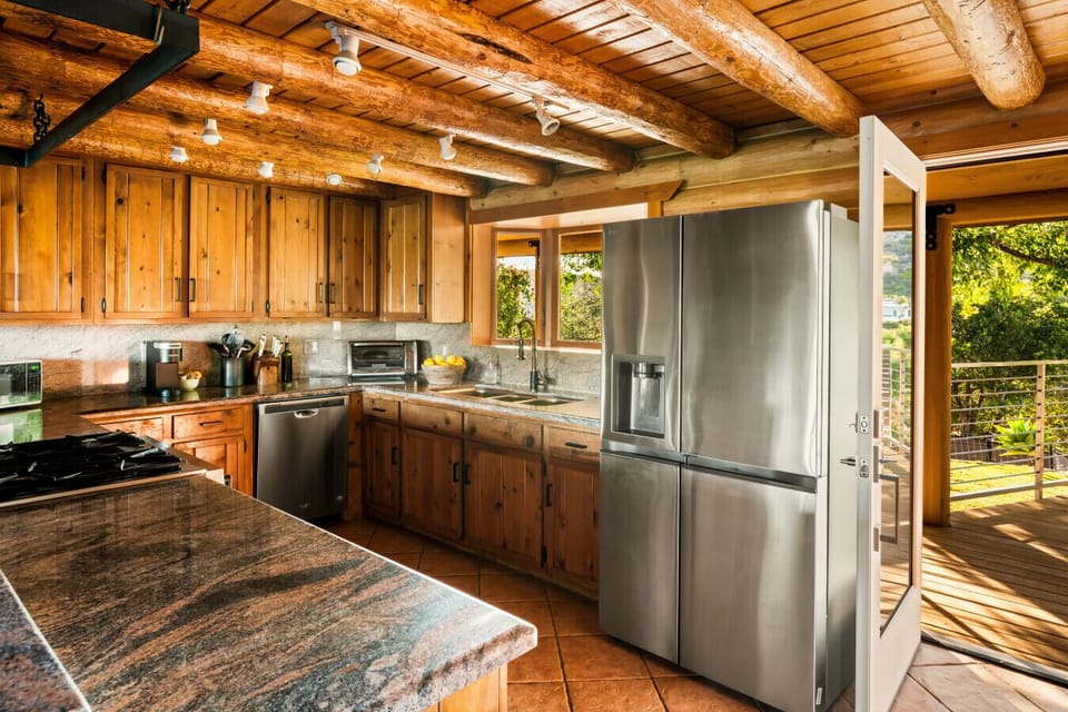 Cook in style surrounded by warm wood tones and sleek finishes.
