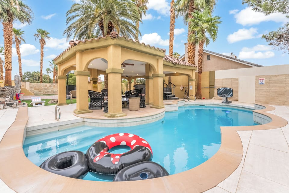 Relaxing backyard with a private pool, spa, shaded patio, outdoor lounge, & BBQ