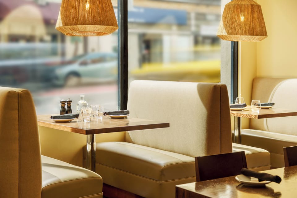 Sip coffee in cozy booths with soft lighting and street views.