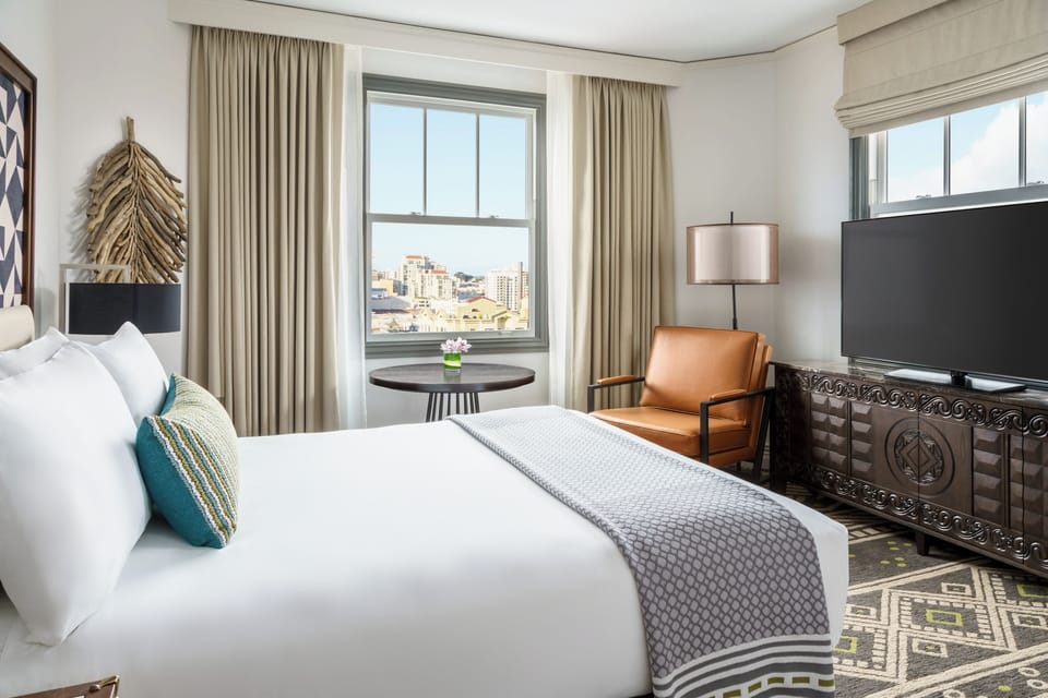 Wake up refreshed beside bright windows and skyline views.