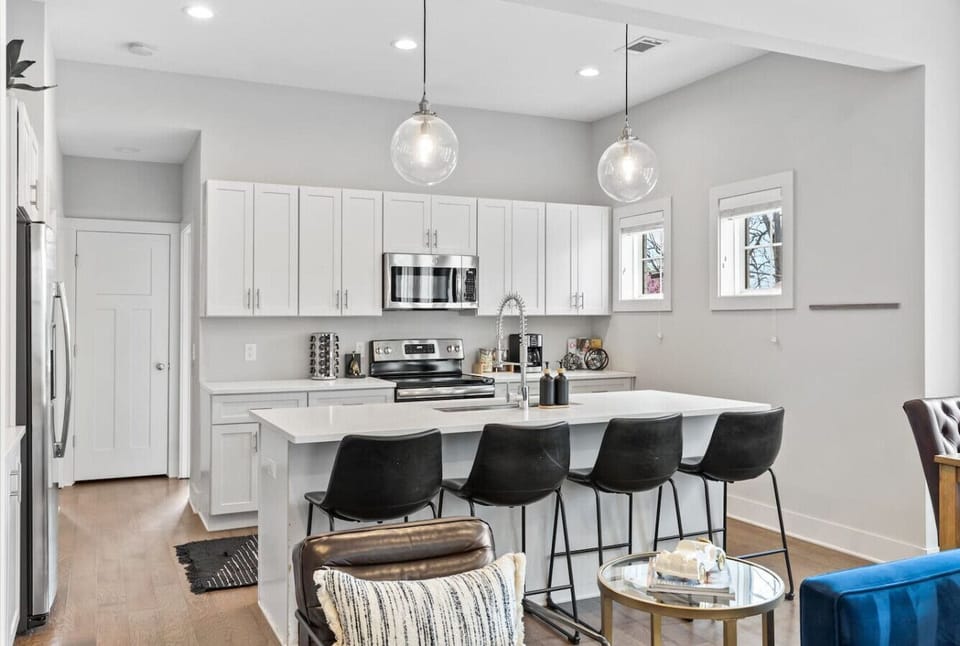 Fully-equipped chef's kitchen with high-end appliances and everything you might need to enjoy a meal at home. Seating for four at the kitchen counter.