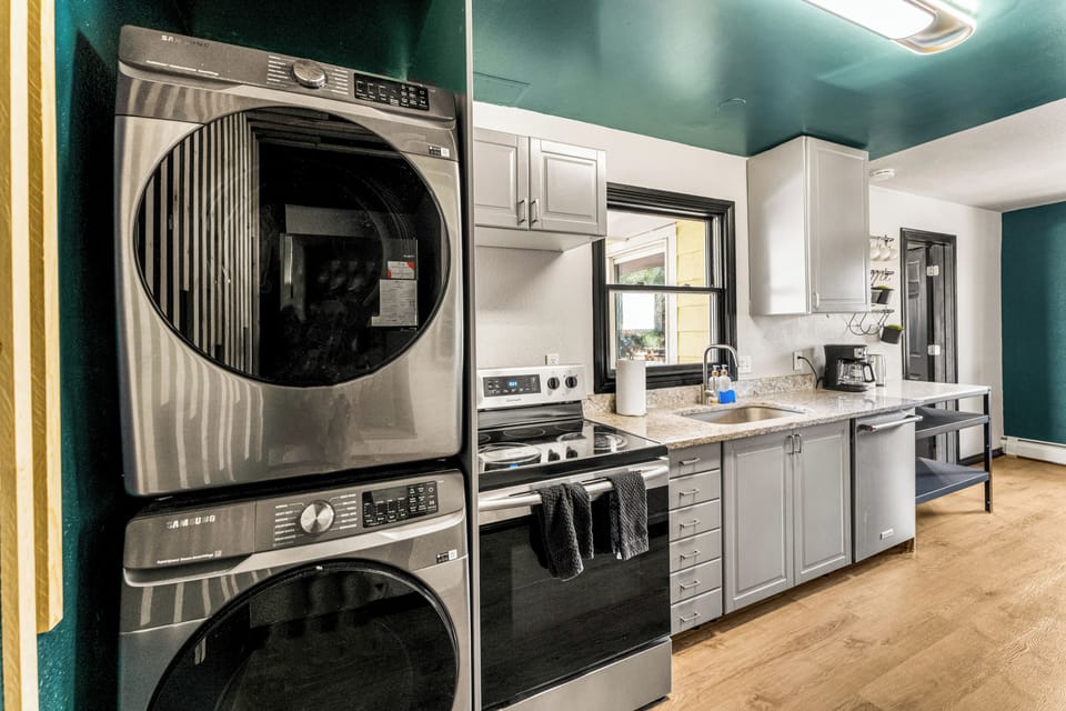The laundry area is equipped with a washer and dryer to refresh your wardrobe while traveling.