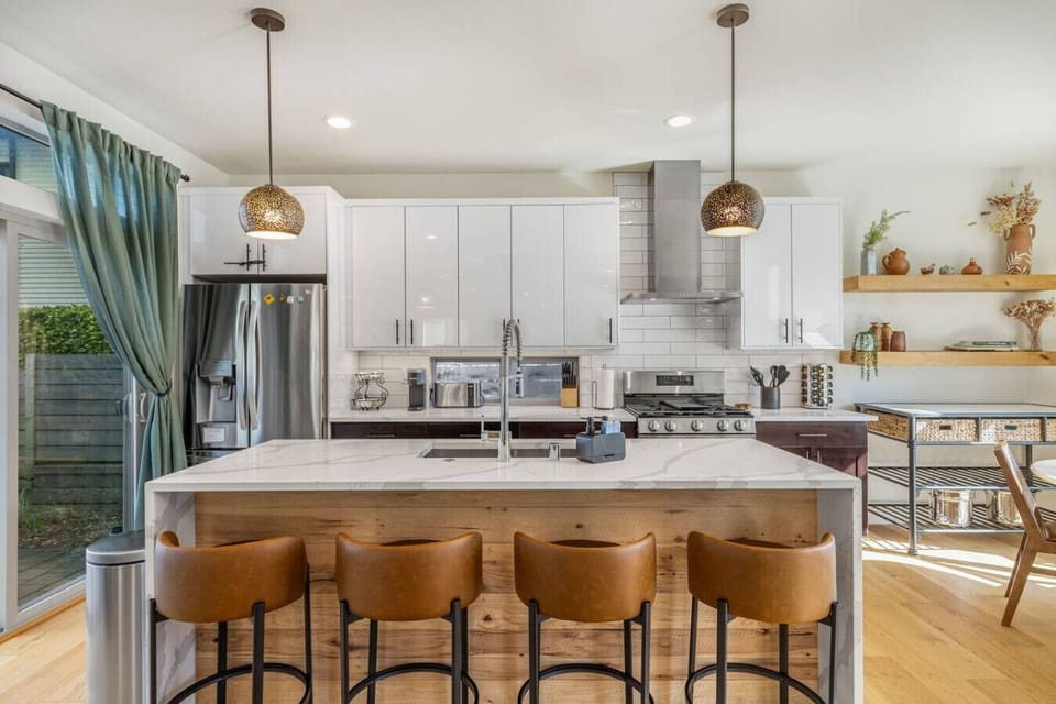 The kitchen island enhances the charm of this open-concept space, making it the perfect spot for bonding and creating memories while cooking together.
