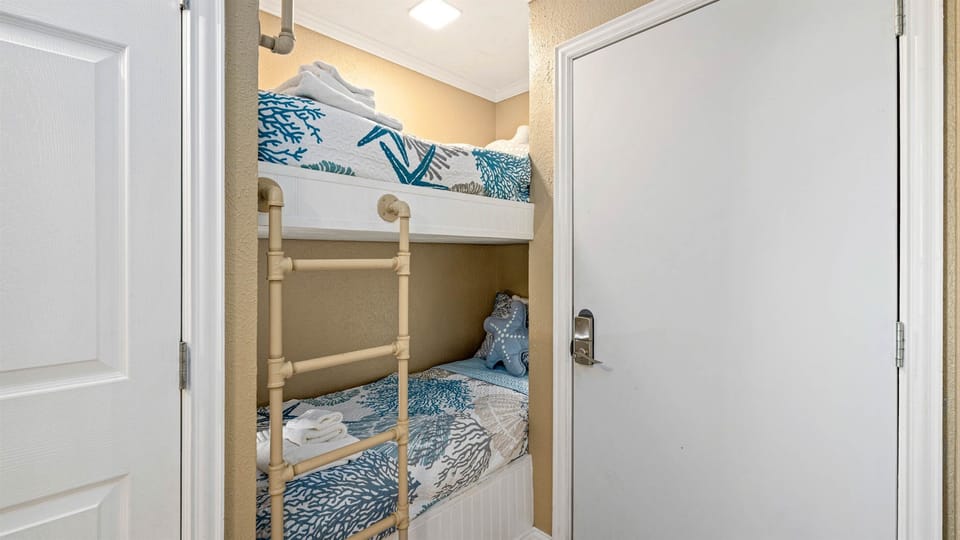 Two cute and cozy bunks near the entrance.