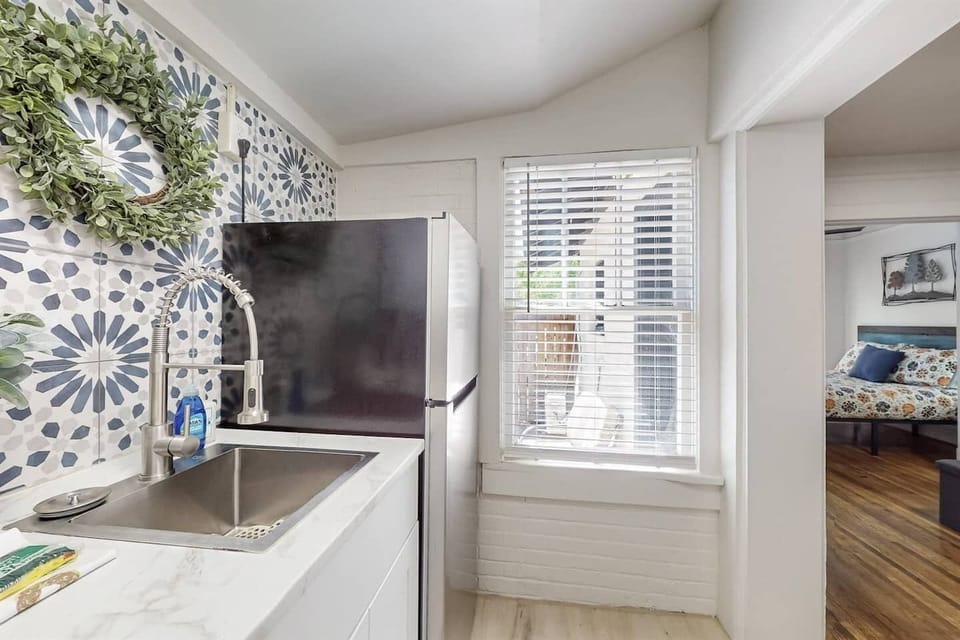 Full refrigerator and stove with a great window to see at the front door.