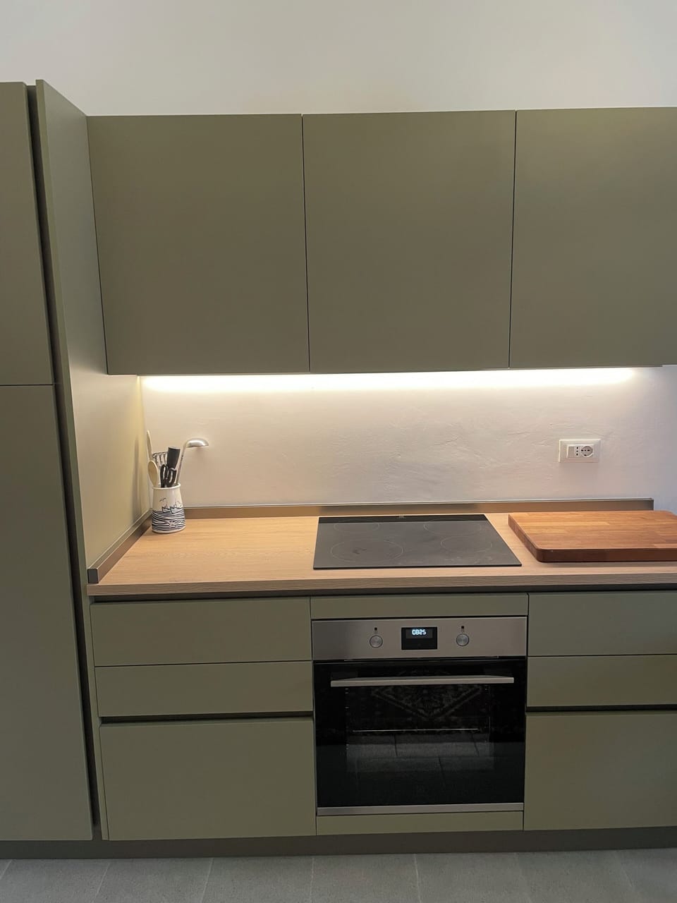 kitchen with induction hob, electric oven, extractor fan