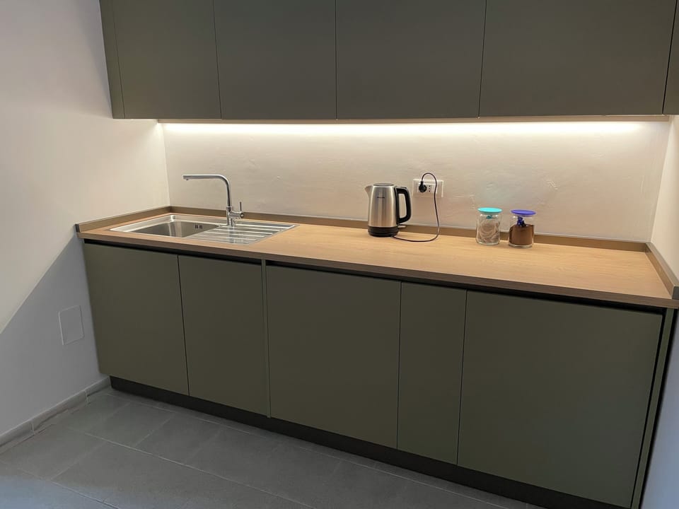 kitchen with sink, bin unit, 45cm dishwasher, washing machine and fridge