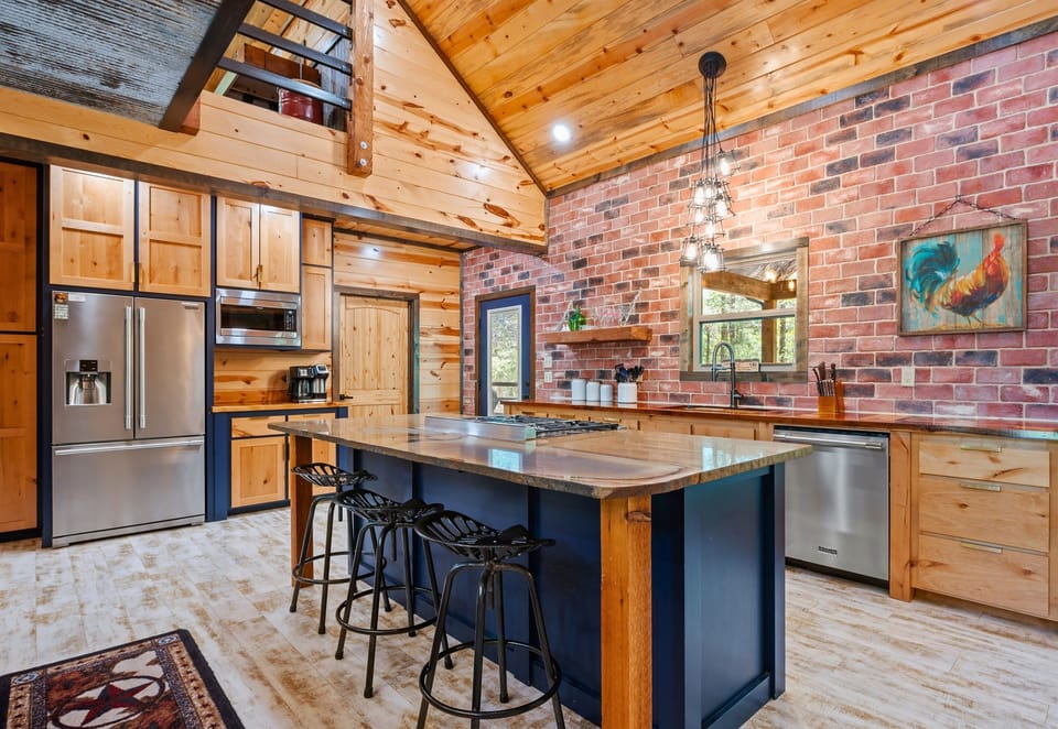 The spacious kitchen island invites casual breakfasts, evening cocktails, and plenty of counter space for group cooking sessions.