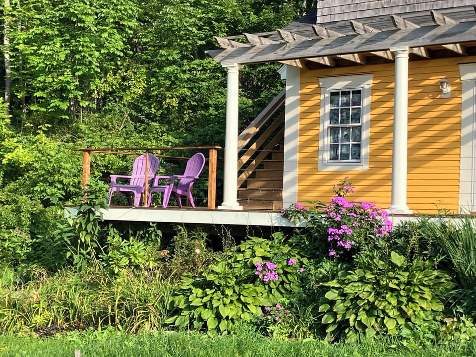 Outdoor guest area on front deck (stairs behind are private access to studio)