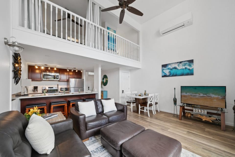 Spacious living room with high ceilings, a smart TV, and direct access to the lanai.
