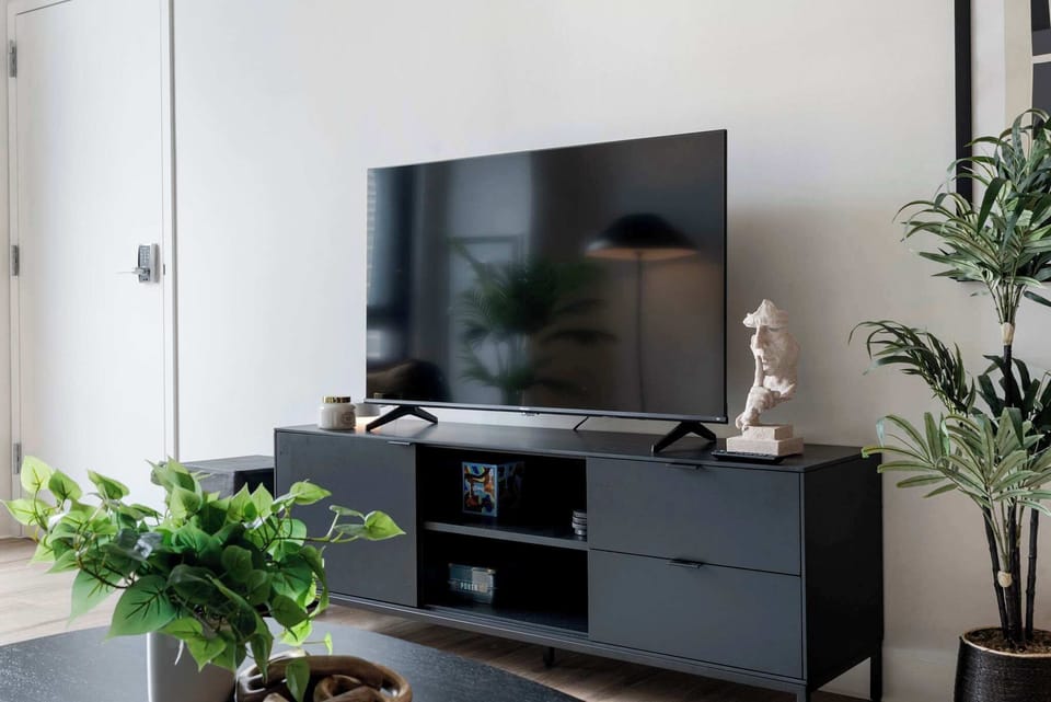 Entertainment setup w/ a TV console and clean design, perfect for movie nights in.