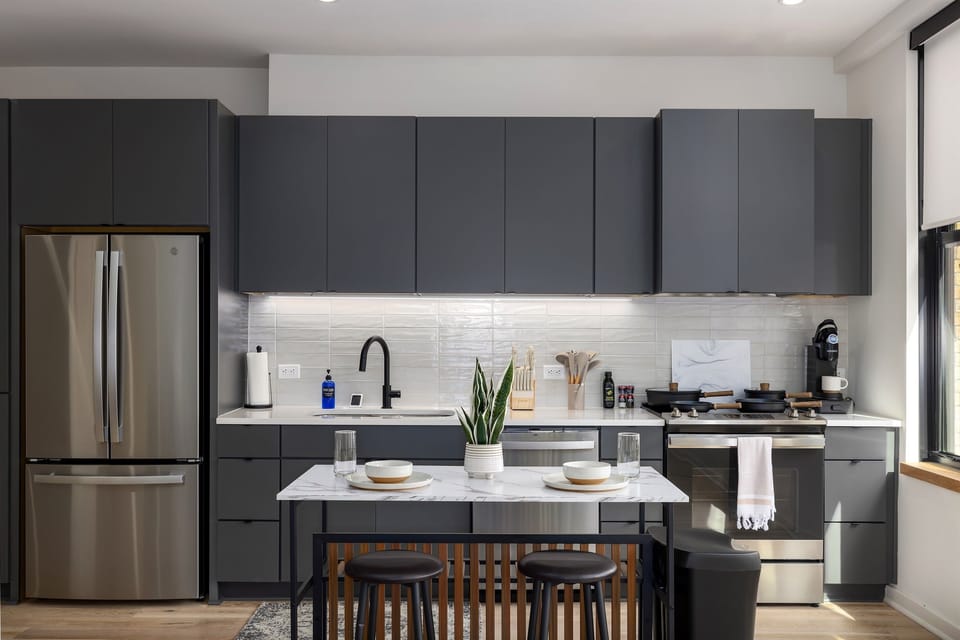 A modern haven—take in the open, airy space of this beautifully designed condo, where the kitchen, dining, and living areas flow together seamlessly.