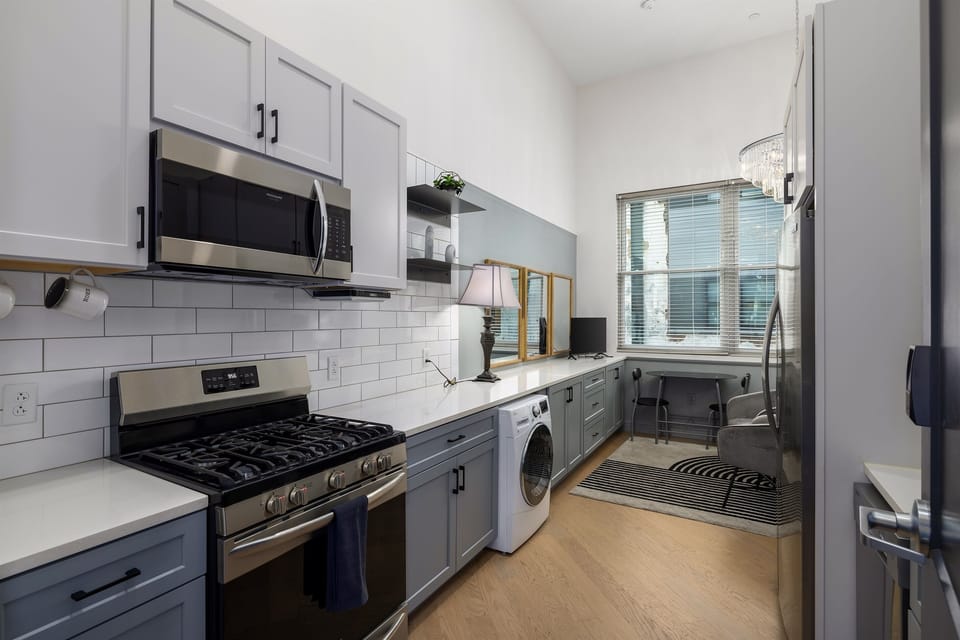 Compact yet fully functional kitchenette with modern appliances, perfect for quick meals or light cooking.