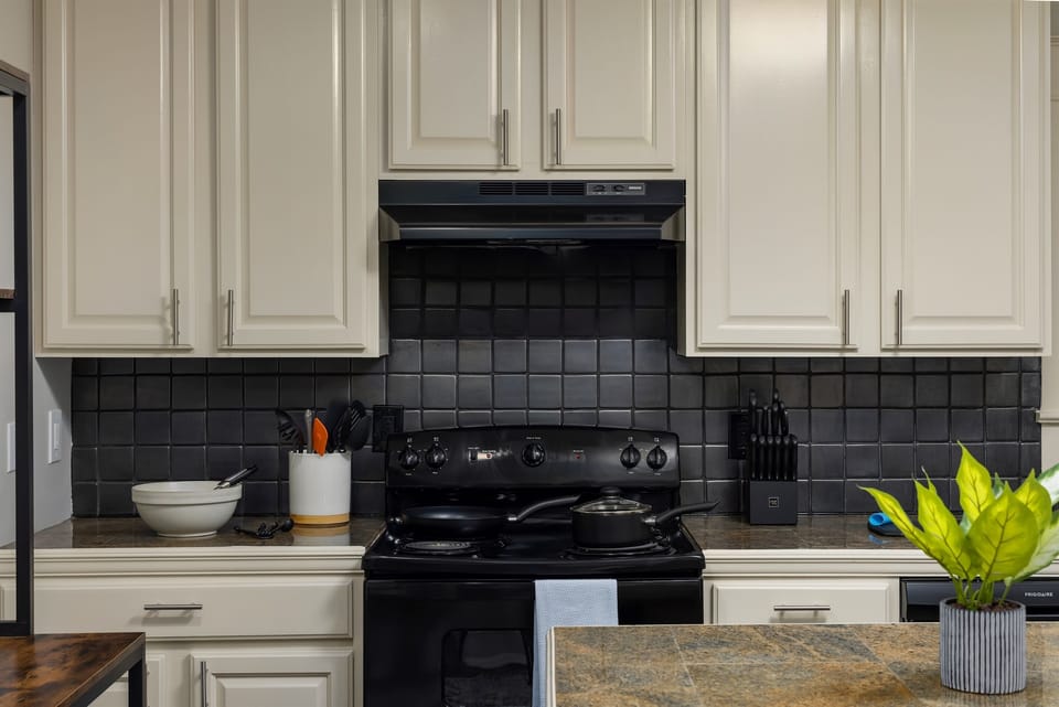 Culinary Delight: Our fully equipped kitchen awaits the aspiring chef, stocked with a variety of pots, pans, and all the essentials needed to prepare delectable meals, just like at home.