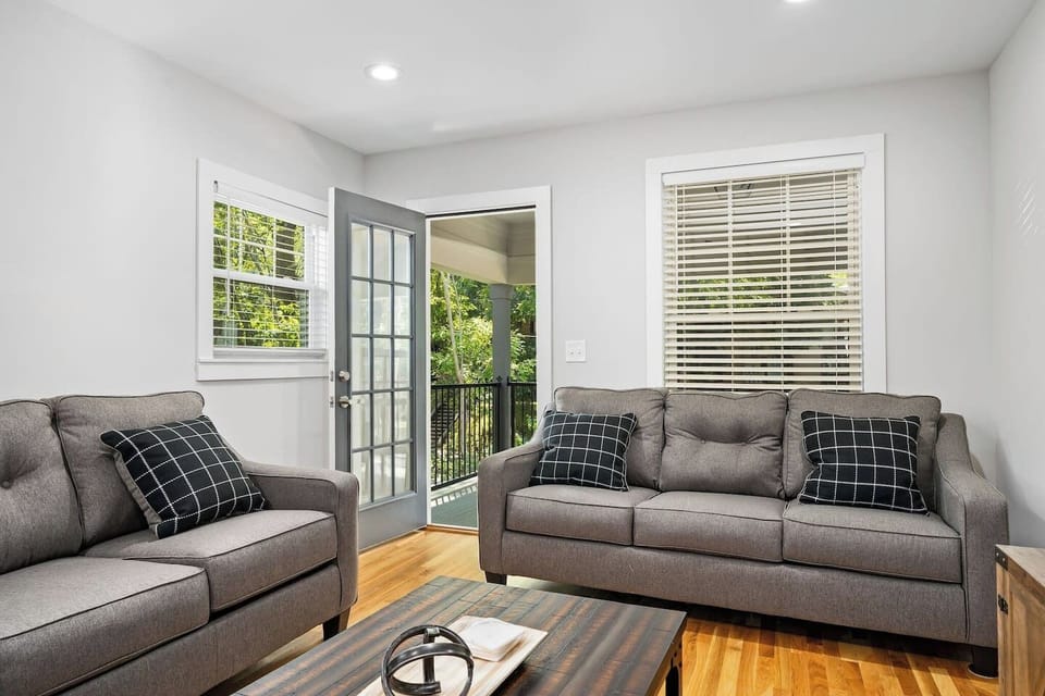 Shows the full extent of the living room's cozy setup and elegant wood flooring.