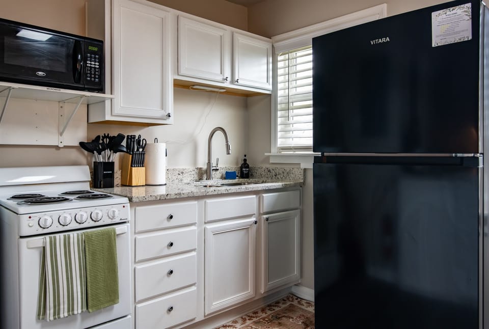 Modern kitchen, fully equipped for any culinary adventure, featuring sleek appliances and ample counter space. *NO DISHWASHER*