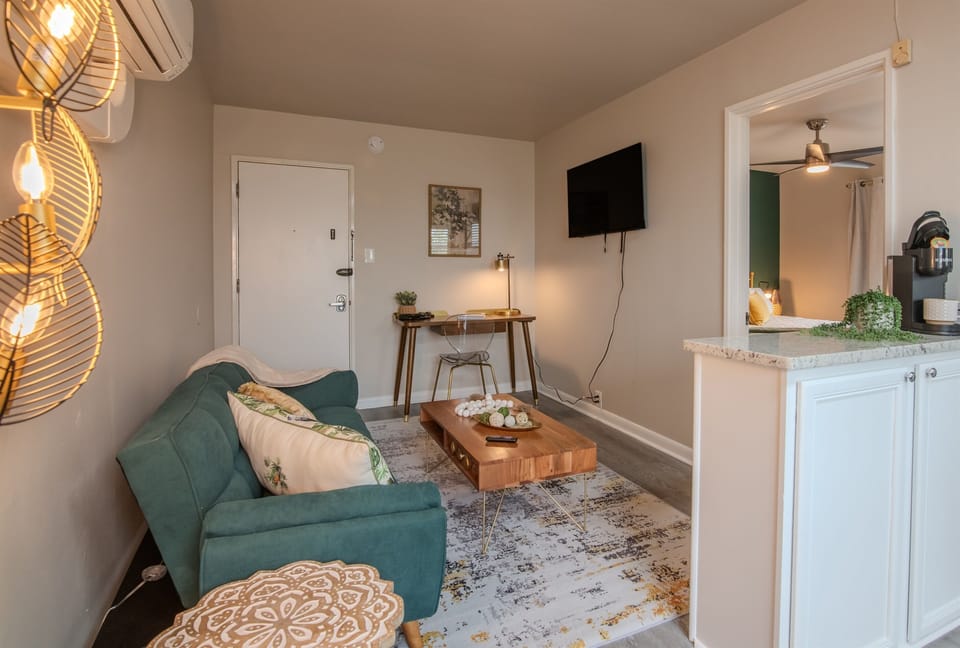 Open layout from living room to kitchen, featuring modern decor and cohesive design.
