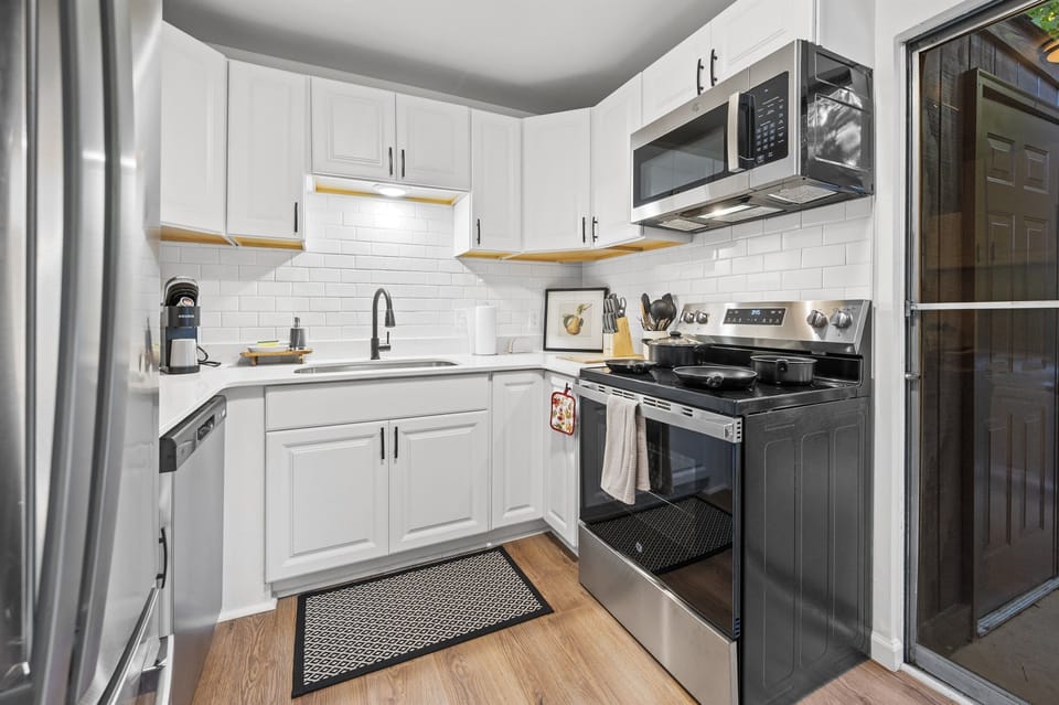 Experience culinary convenience in our fully equipped kitchen, featuring modern appliances and essentials for your stay. 