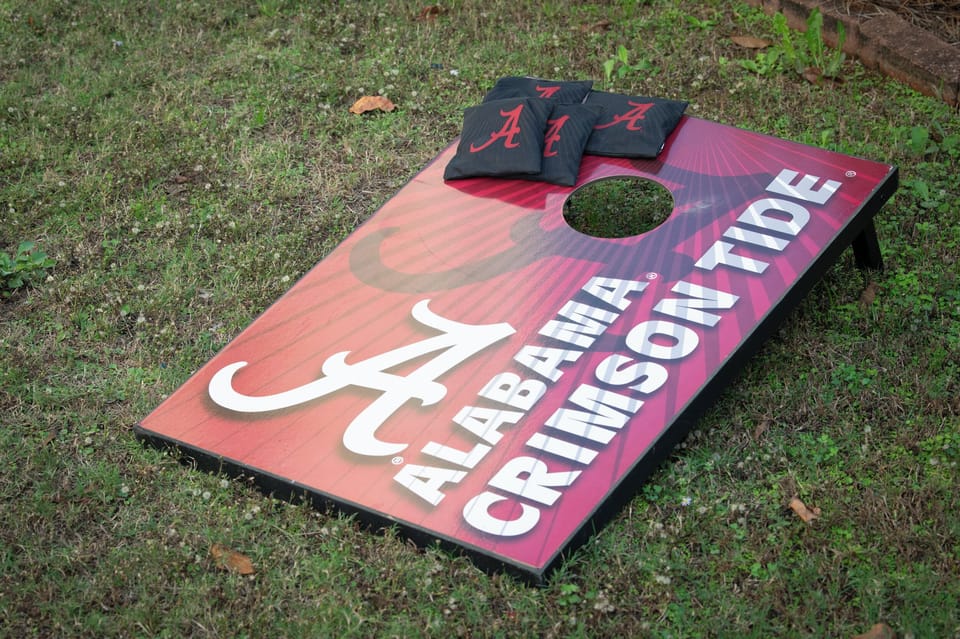 Show your team spirit with a fun game of cornhole on the Crimson Tide board!
