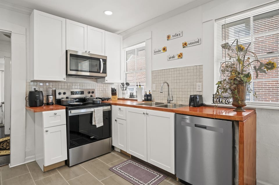 Fully equipped kitchen with stove, oven, microwave, and air fryer for all your culinary needs.