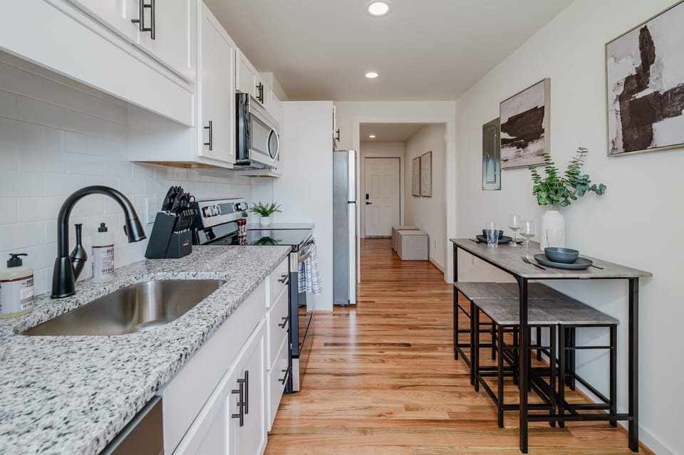 View the sleek kitchen from the dining area, perfect for social cooking and dining.
