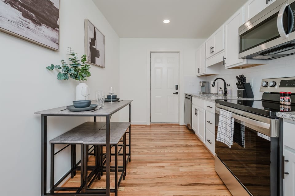 Spacious area combining cooking, dining, and relaxation in one modern setting.