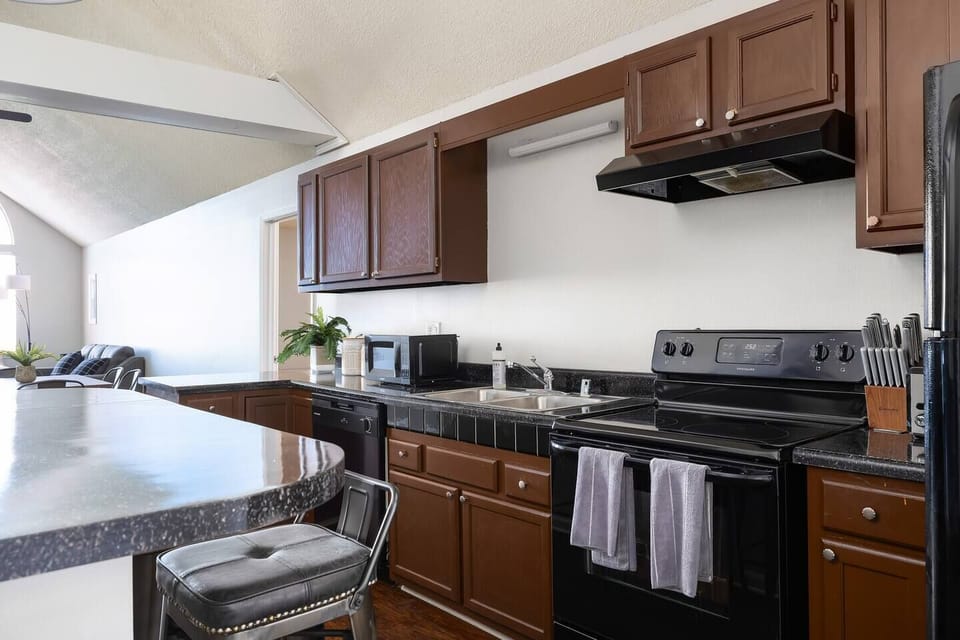 Fully equipped kitchen with sleek countertops, a stovetop, and plenty of workspace.