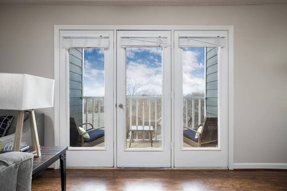 Close-up of French doors leading to the balcony, offering a bright and inviting outdoor space.