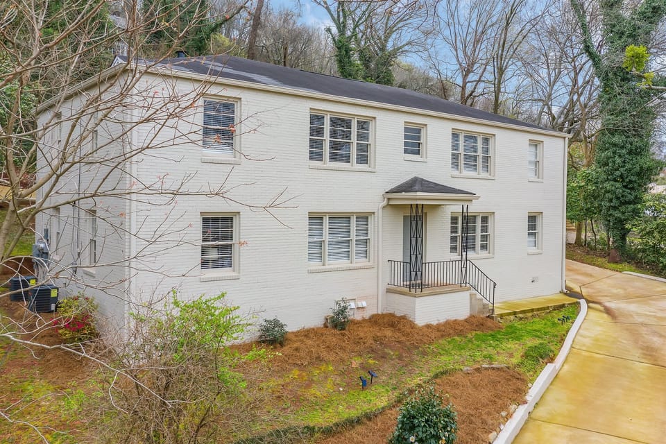 The clean lines of this well-maintained building are complemented by lush greenery, making this property both modern and inviting.