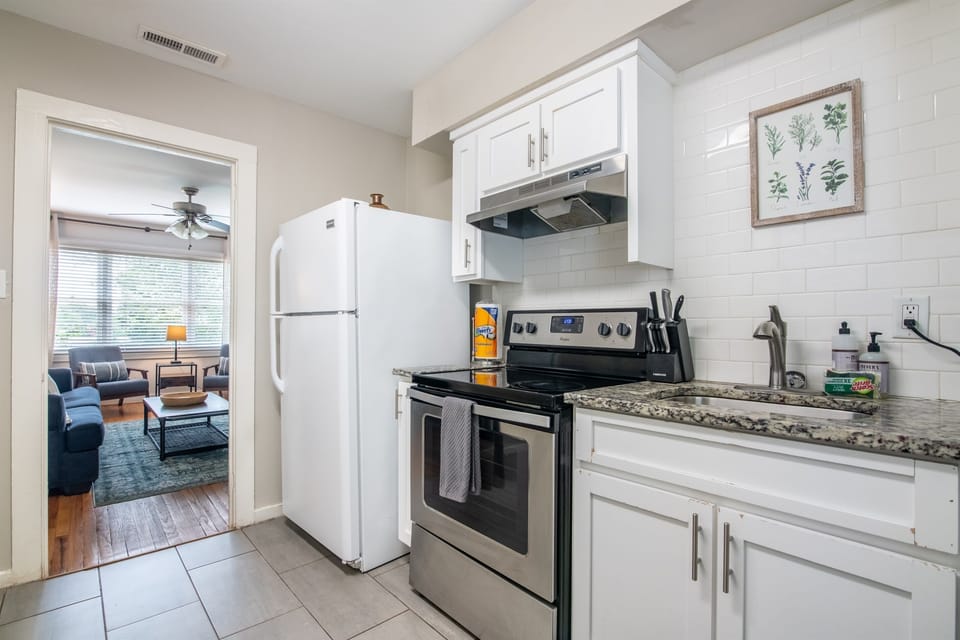 Another angle of the kitchen showing ample counter space and updated appliances.