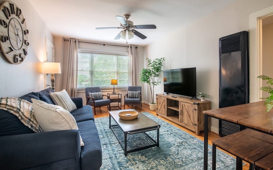 Bright and cozy living room with comfortable seating and a smart TV — perfect for relaxing after a day out.