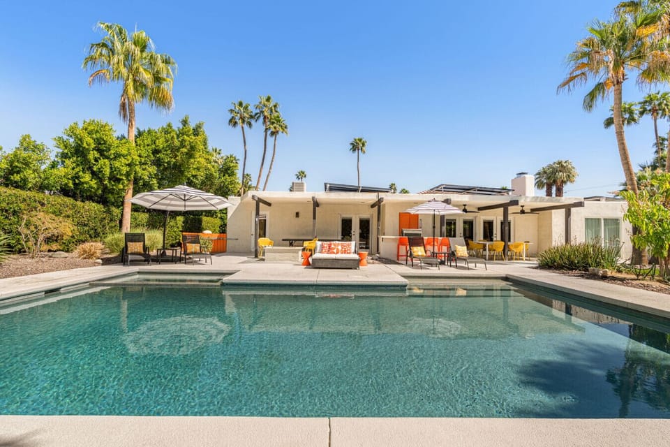 Spacious backyard pool area w/ multiple loungers & open sightlines for all-day sun.
