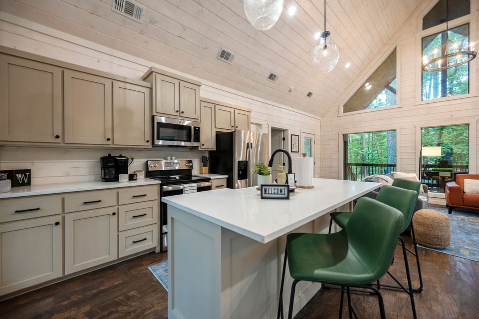 Bright modern kitchen with sleek appliances and cozy dining space.