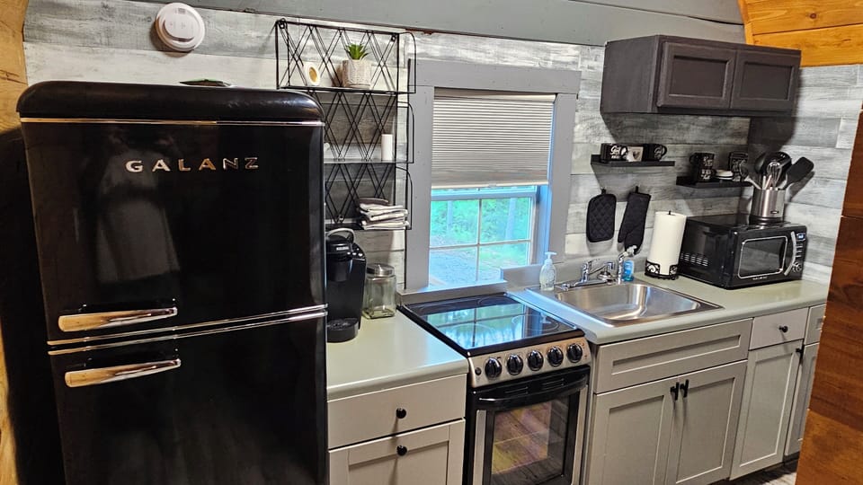 full kitchen. microwave, oven, k-cup coffee maker. refrigerator.