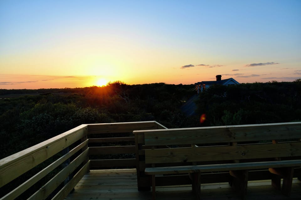 Sunset over the creek, as seen from the second story of the lookout on the beach
