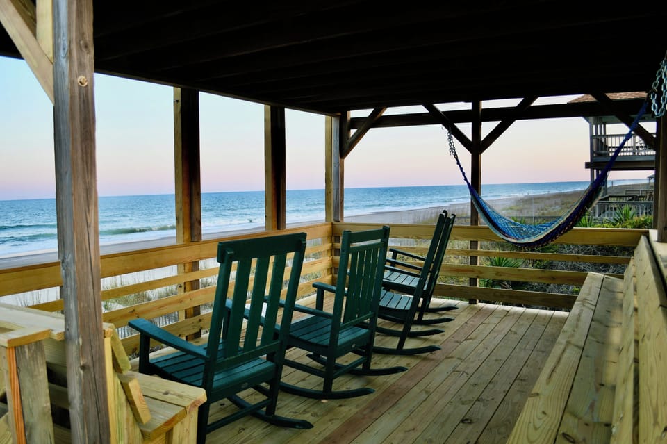 Rocking chairs and hammock overlooking the beach 