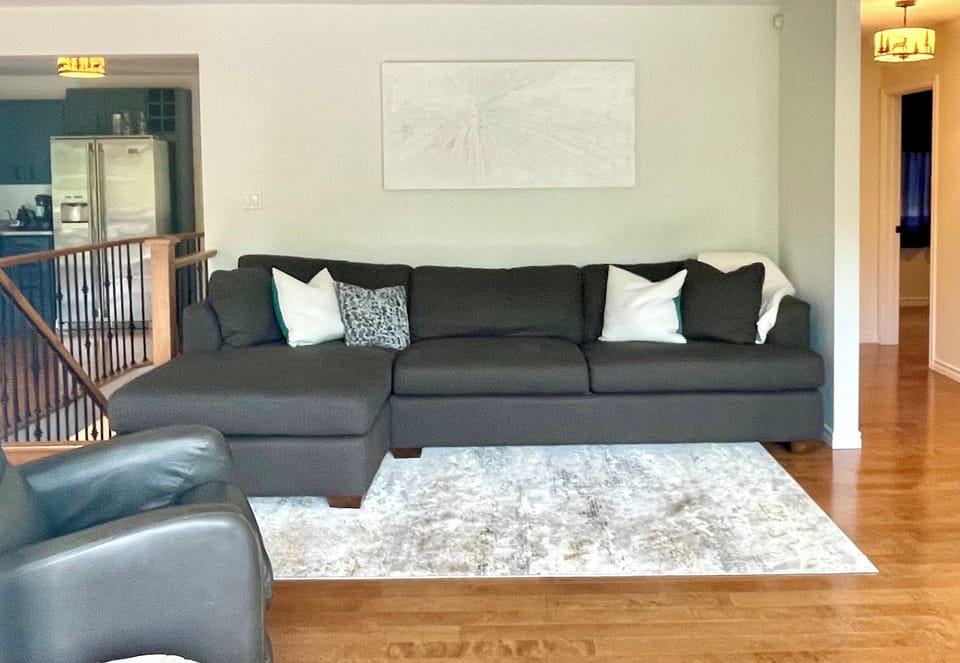 Living room, large comfy couch and leather lazy-boy rocking chair
