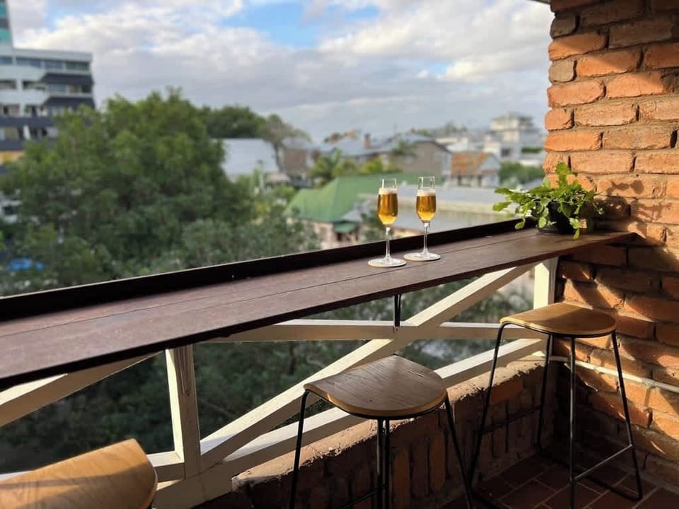Coffee or wine either way, this balcony’s the best seat in the house for rooftop and treetop views