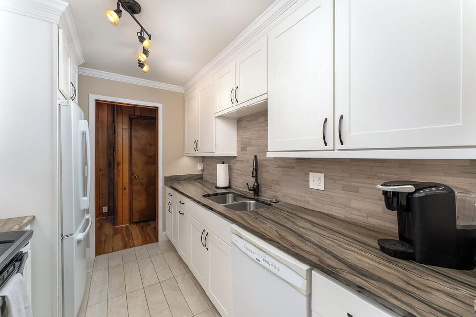 Updated kitchen with stainless steel appliances, dishwasher, and Keurig coffeemaker.