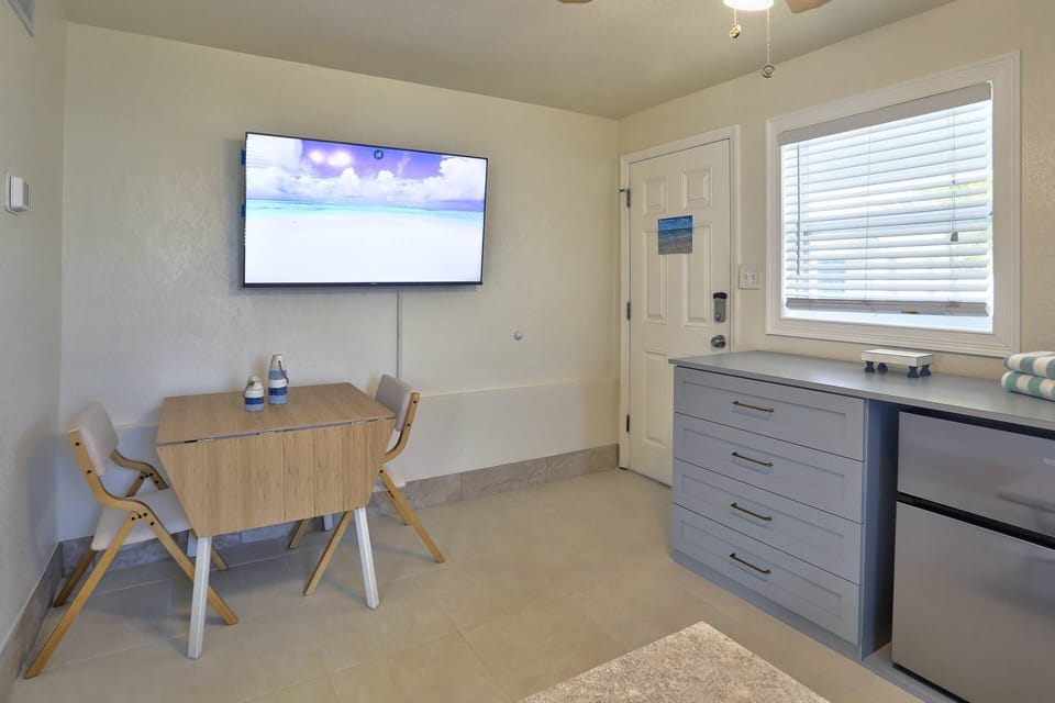 An open layout to watch TV on the cozy living room sleeper couch or dine indoors