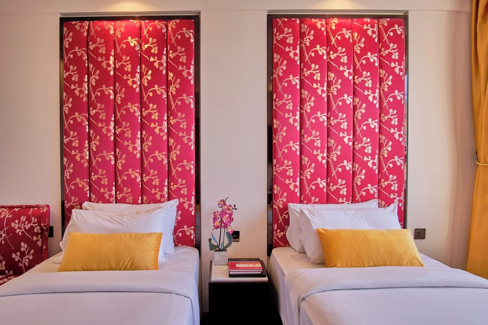 Drift into restful sleep in perfectly made twin beds.