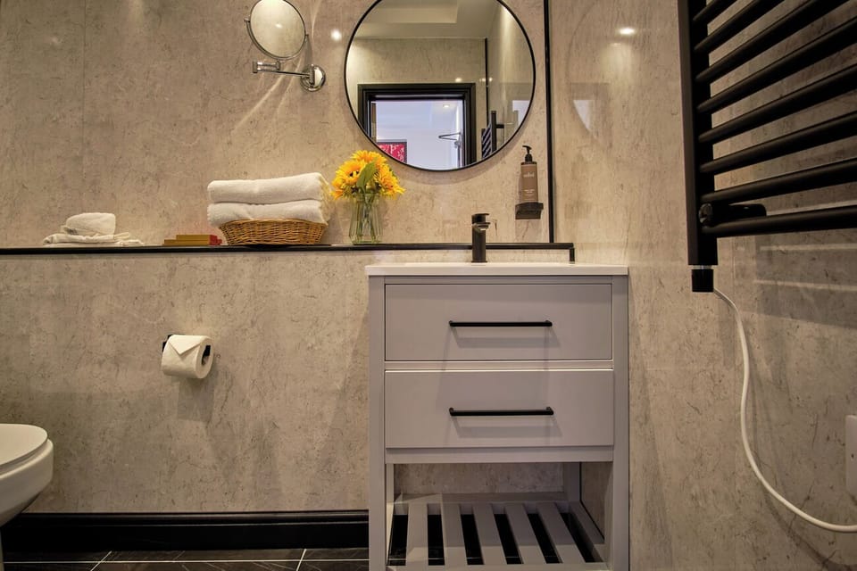Unwind at the polished vanity with fluffy towels ready.