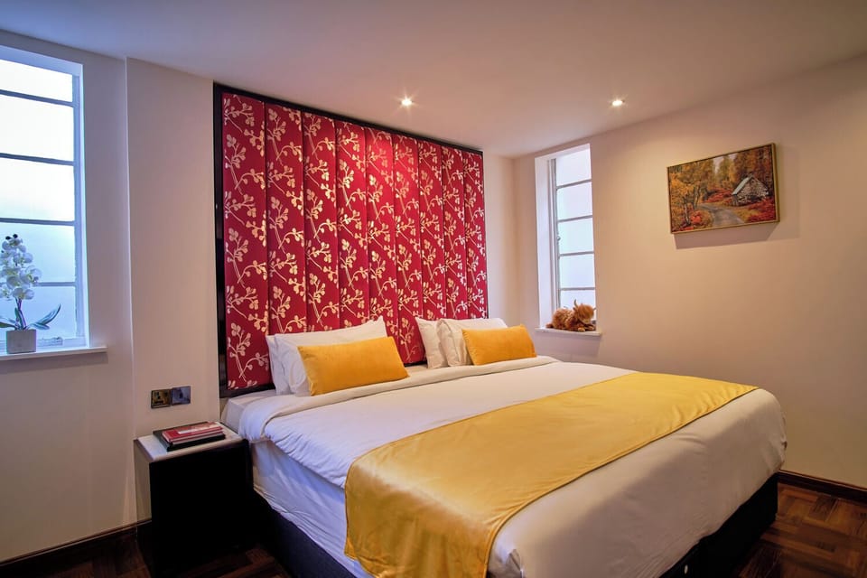 Unwind into crisp linens beneath bold, boutique-style accents.