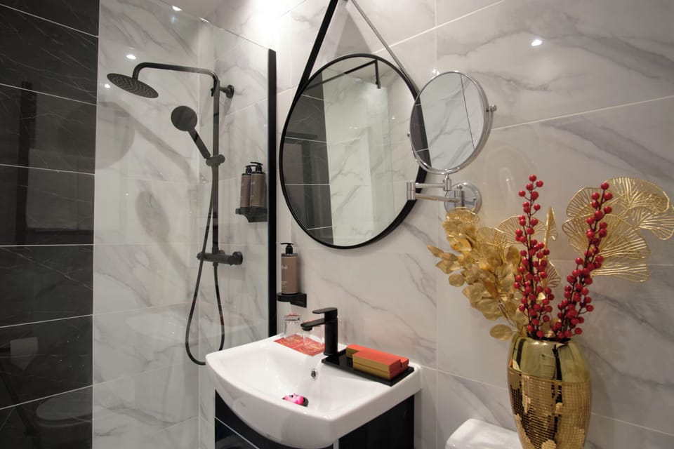 Refresh under a sleek rainfall shower with spa-like details.