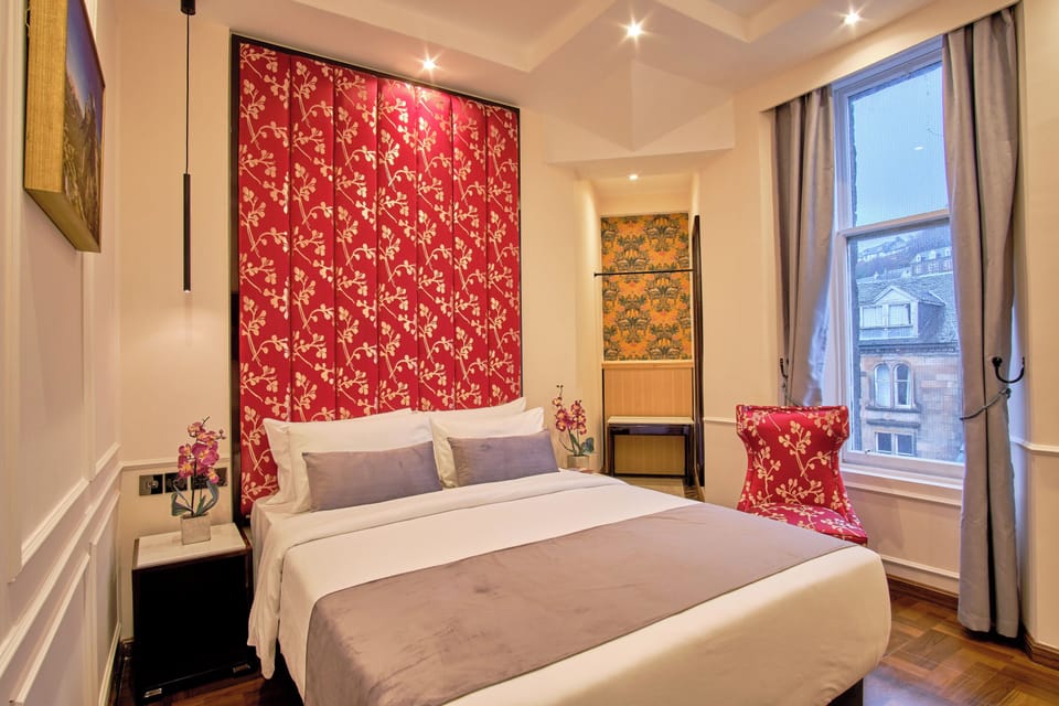 Relax in a serene bedroom with plush pillows and city views.
