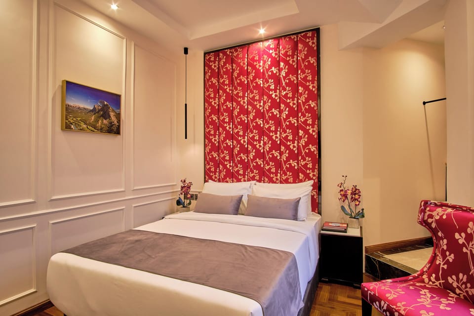 Unwind in crisp linens beneath the bold, boutique headboard.